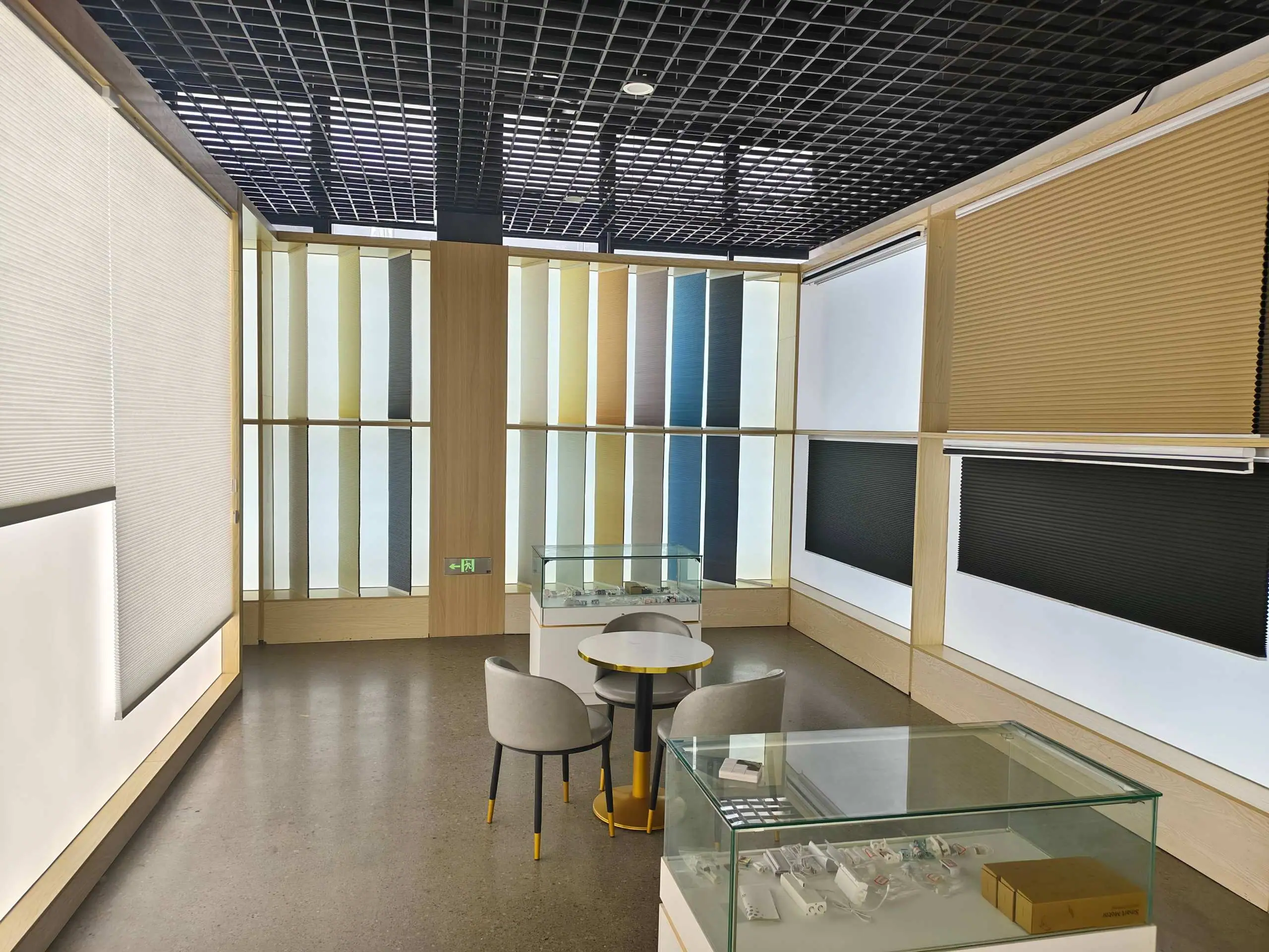 CAIC showroom lounge surrounded by backlit honeycomb shade samples in many colours