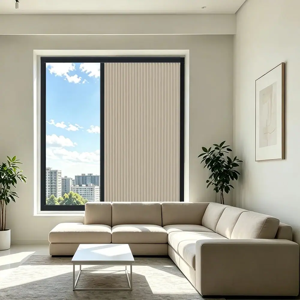 Sand-coloured cellular shade over a tall living room window with a city view